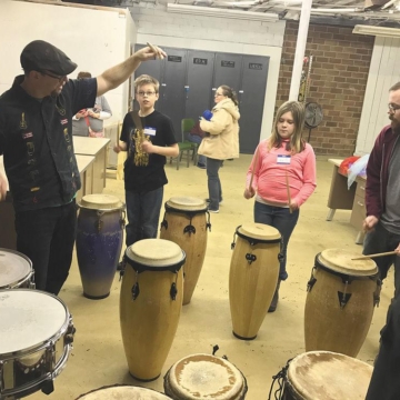 Josh Dunigan plays a beat on the tom for Aidin Houkwater, his sister, Ava, and their father, Aaron. By RILEY KELLEY | Daily News