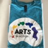 Arts in motion palette logo printed on Gildan Softstyle blue-hue colored shirt.